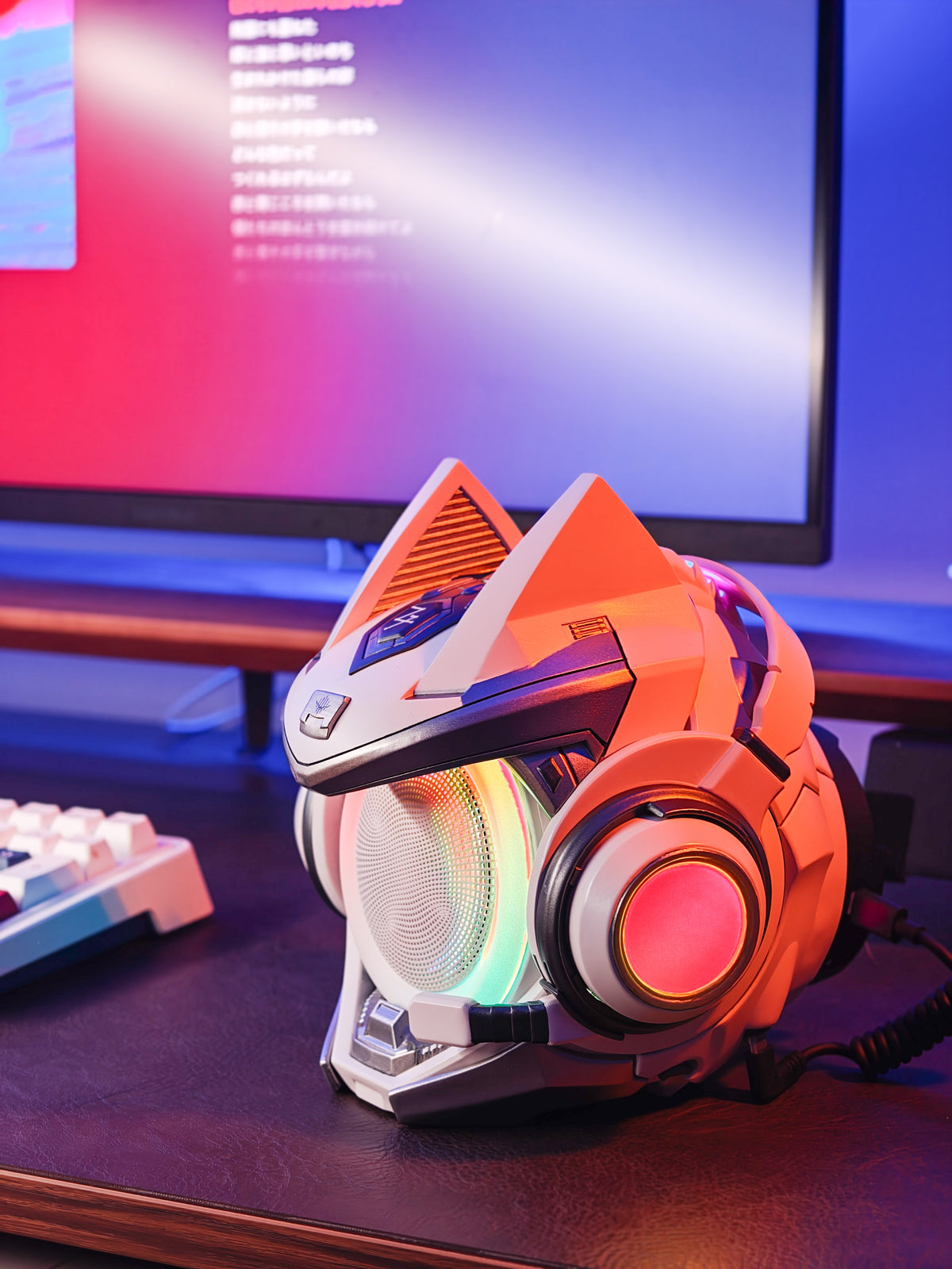 Orange OLLIE figure speaker with RGB lighting on a desktop