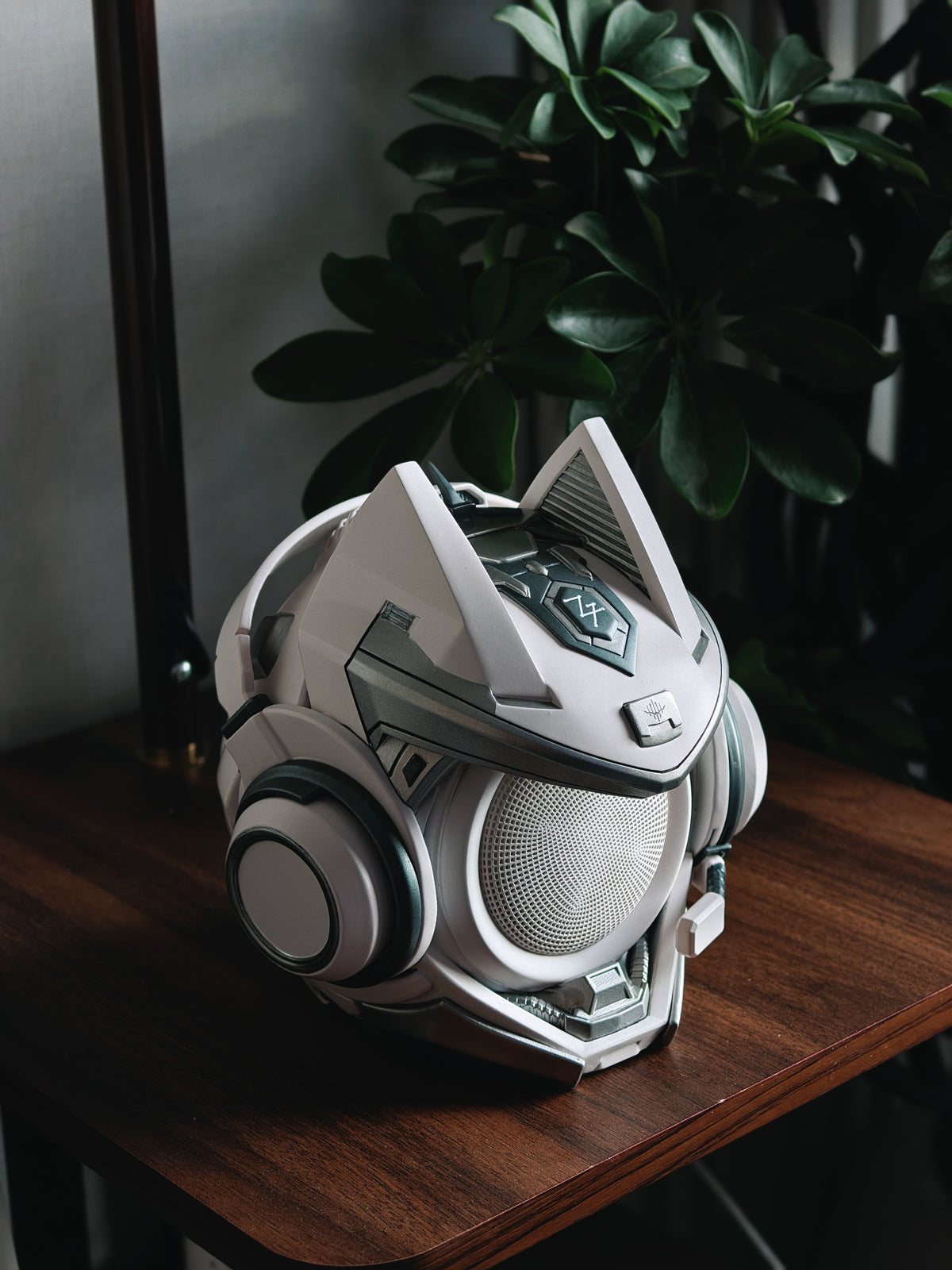 Silver OLLIE figure speaker on a wooden table